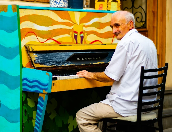 man playing upright piano